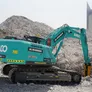 A medium 35-ton KOBELCO SK350 excavator fitted with a Jisung jackhammer