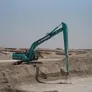 A Kobelco SK500 long boom track excavator on an Al Marwan Abu Dhabi job site