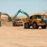 Multiple 40 to 45 ton trucks, like the Volvo A45G and the Komatsu HM400, on Al Marwan job site