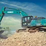 A crushing bucket attached to a Kobelco SK380 excavator.