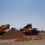 A couple of Volvo A40G's on a construction site in the desert