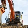 Hitachi excavator attached to a trenching bucket