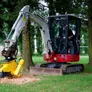 Mini digger attached to a stump grinder