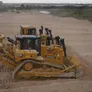 Dozers' rippers used to loosen hard materials