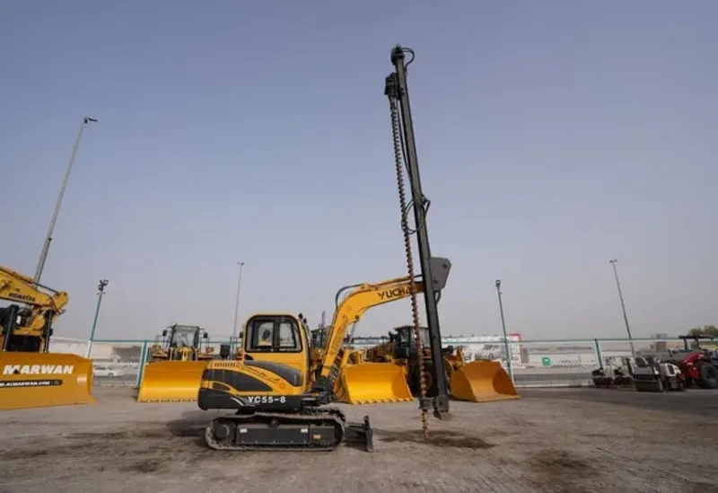 A Yuchai YC55 mini excavator equipped with an auger for post drilling
