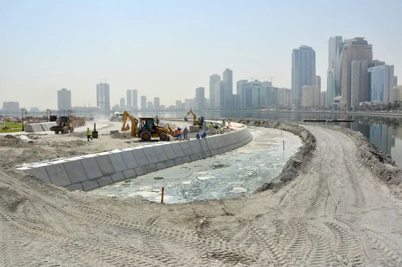 A picture of various road building equipment such as the JCB 3CX backhoe loader excavating and laying foundations for the connecting road between Al Majaz Island and the waterfront