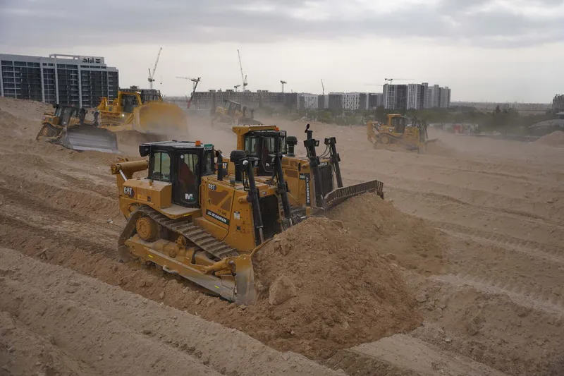 A range of Al Marwan dozers on a job site, like the CAT D8, CAT D9, Komatsu 475A & more