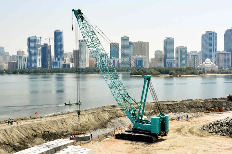 An Al Marwan CKS1350 Kobelco crawler crane on a job site installing prefabricated elements