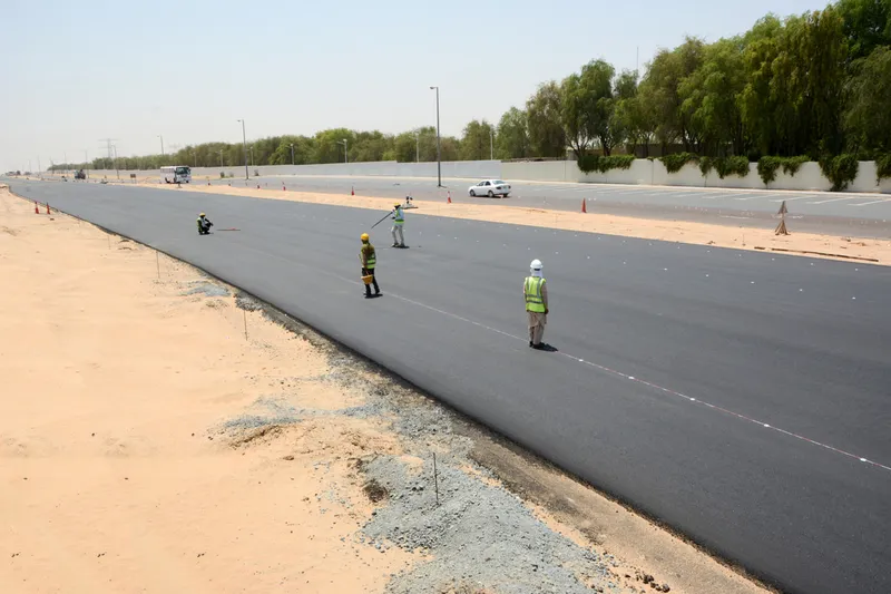 Al Marwan's asphalt division making sure the finishing progress is on schedule using machinery and brick and mortar methods