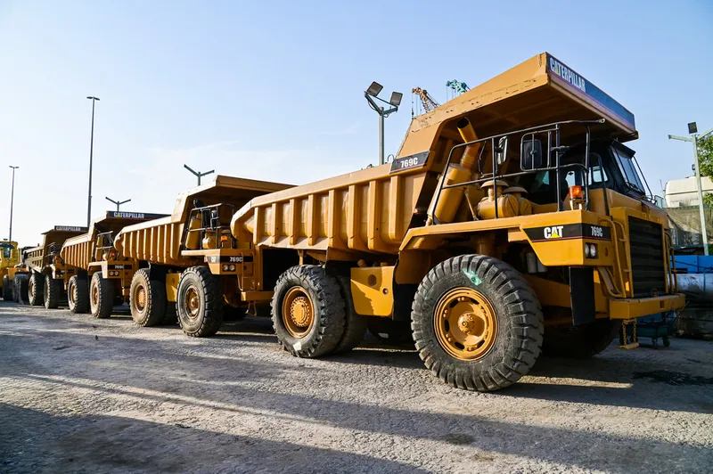 A lineup of Al Marwan's used CAT rigid dump trucks made available for sale on our Industrial Area 2 showroom in Sharjah, UAE