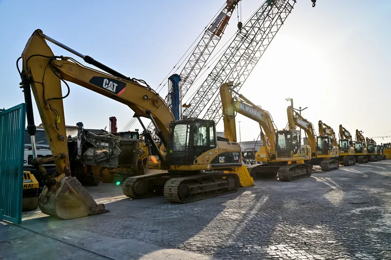 Al Marwan's lineup of CAT and Komatsu medium track excavators at our used equipment showroom in Sharjah, UAE