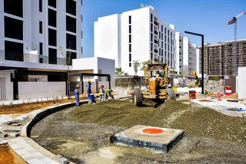 The Komatsu GD755-5R motor grader grading around residential real estate at Al Jada by Arada development project