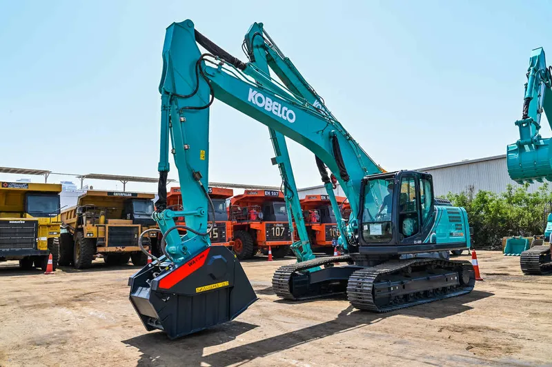 A Kobelco SK220 brand-new excavator equipped with a specialized bucket at Al Marwan yard